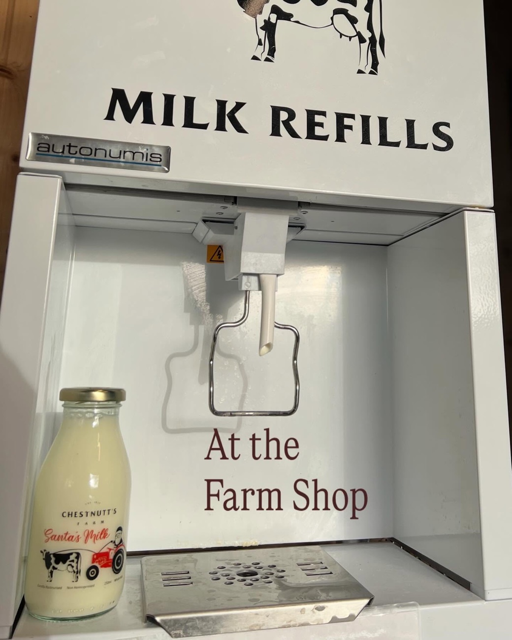 The self-service milk machine at the farm shop, refilling a glass bottle with local Chestnutt's milk