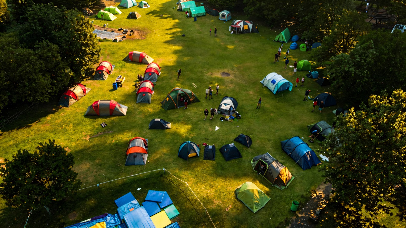 Tents pitched on the meadow for a proper lakeside adventure camp