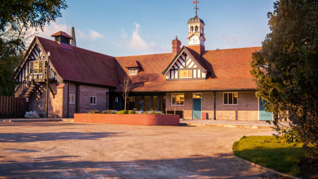 The restored Tudor-style stables at Sion Mills, with their clock cupola above the tiled roofs.
