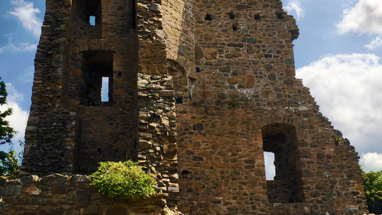 A closer look at the tower's windows and stonework against the sky.
