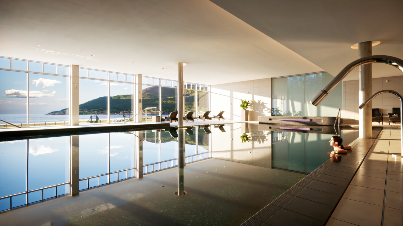 A quiet swim with the beach and Mourne Mountains framed through floor-to-ceiling windows.
