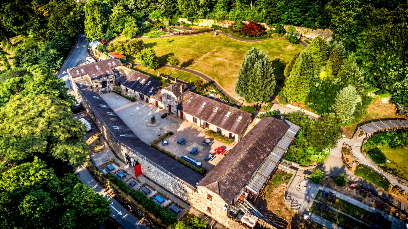 Aerial view of the historic stone-built Slieve Gullion Courtyard buildings surrounded by woodland