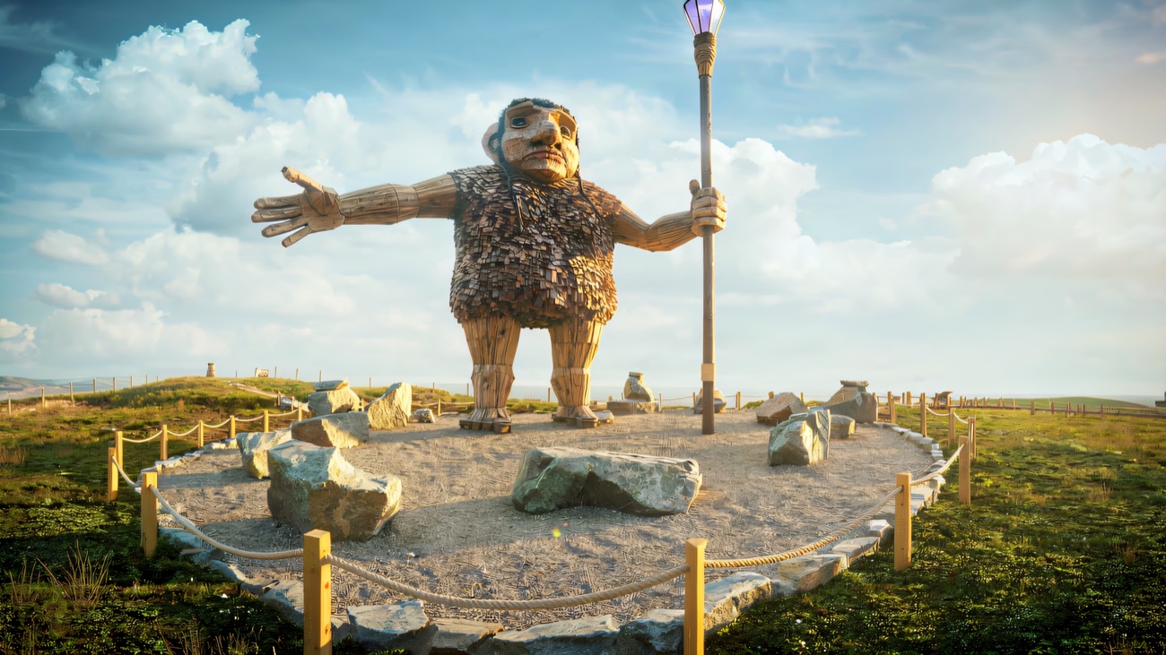 The giant seen head-on, one arm out in welcome, on his summit plinth above the glens.