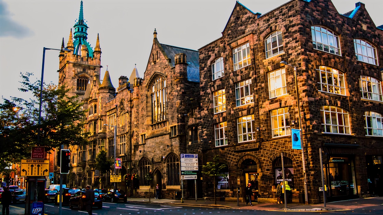 The clock tower and copper spire of Church House rising over the street corner in Belfast city centre