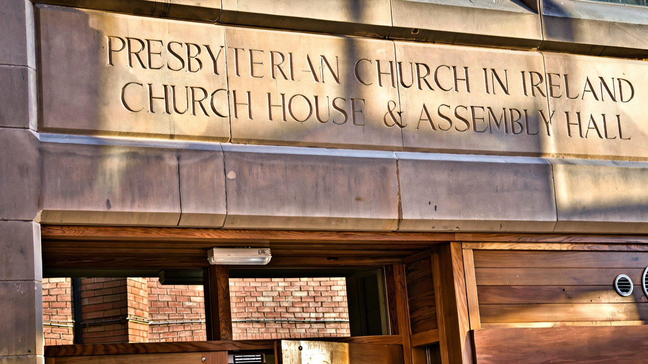 The carved sandstone lintel over the main doors reading Presbyterian Church in Ireland, Church House and Assembly Hall