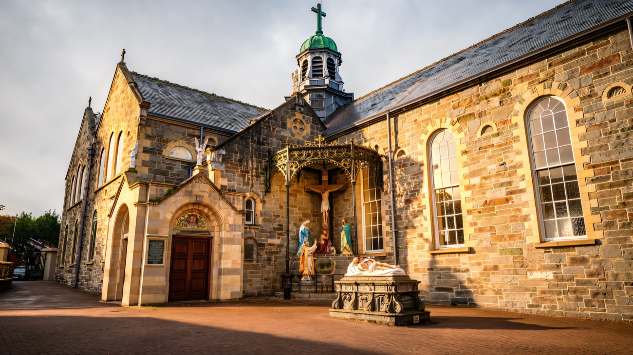 The Long Tower Church seen from the side, its green-domed cupola above the outdoor crucifixion shrine.