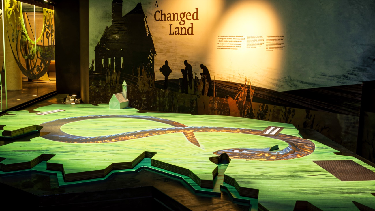 The 'A Changed Land' exhibition, with its lit floor map and projected scenes.