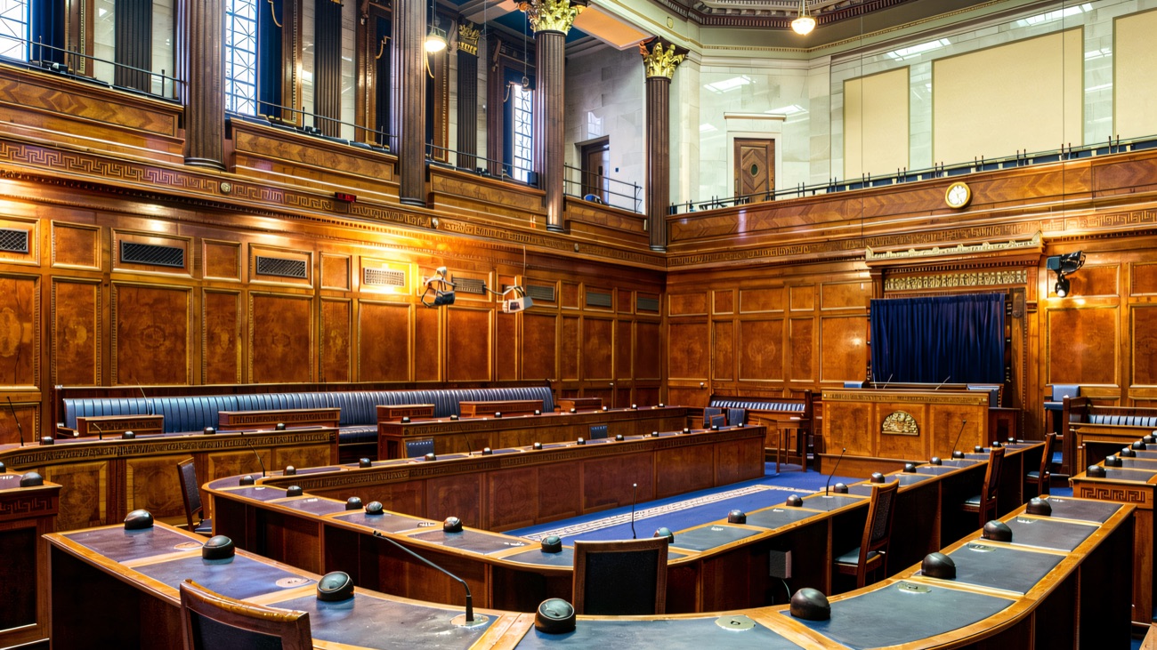 The Northern Ireland Assembly debating chamber, with its blue benches and wood panelling