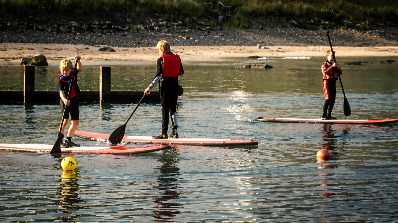 A SUP session gliding out past the beach on a sunny morning