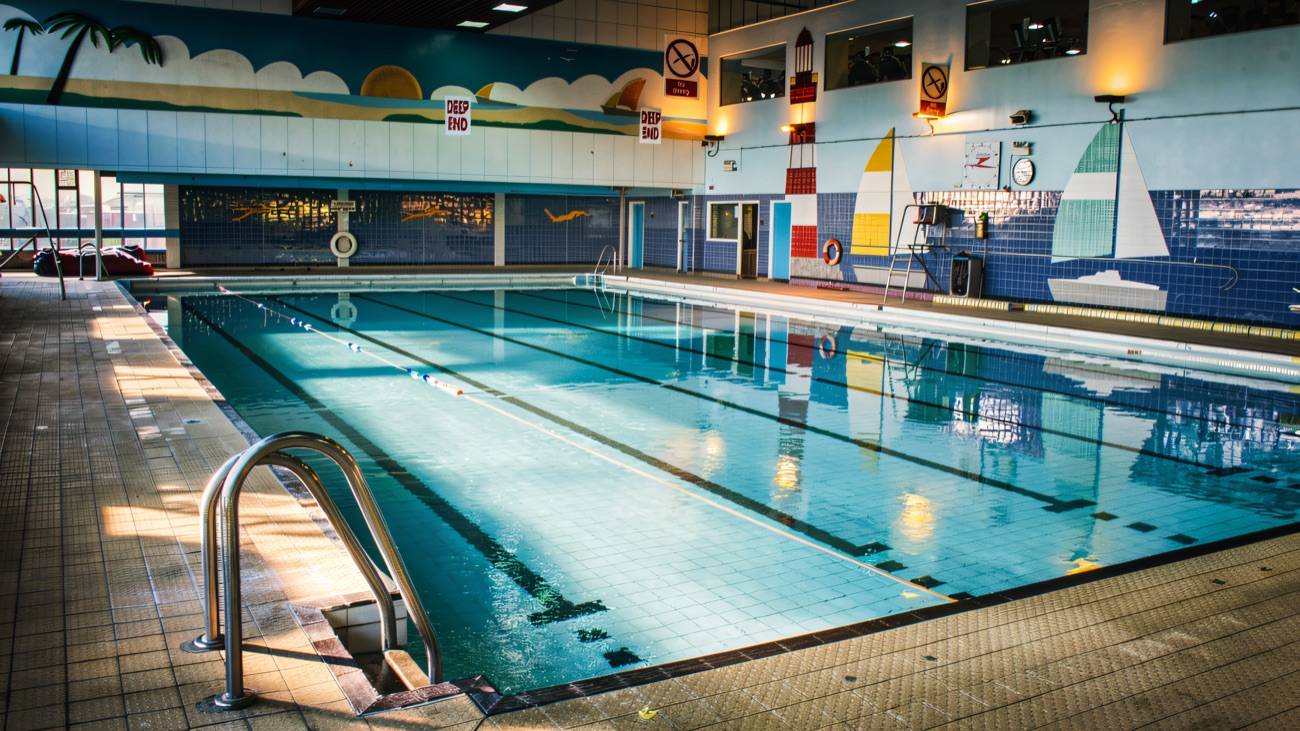 The pool with its painted seaside mural along the far wall