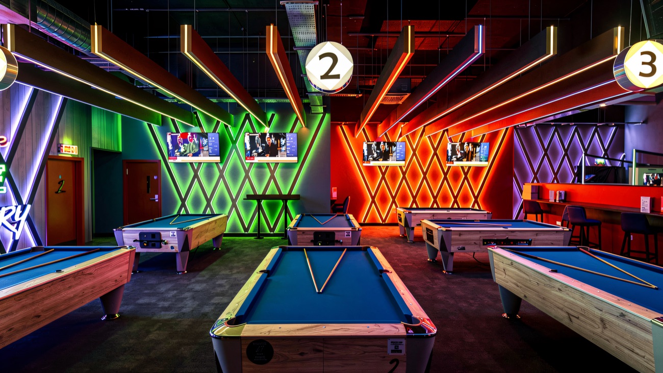 Neon-lit pool tables in the games room