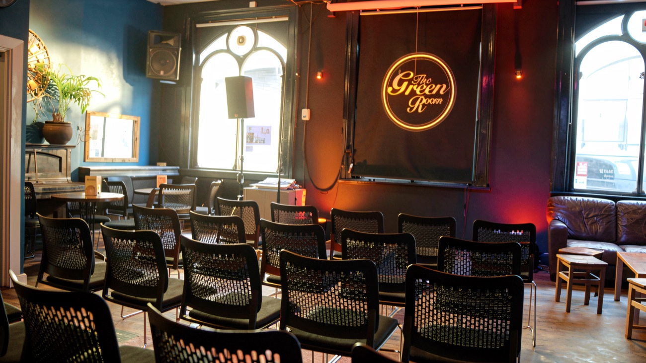 The Green Room set out with rows of chairs facing the stage