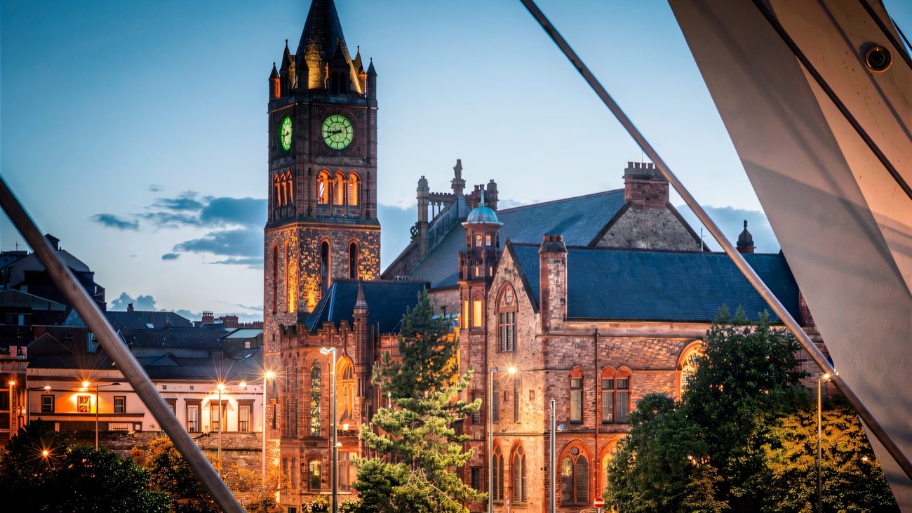 The green-lit clock tower at twilight