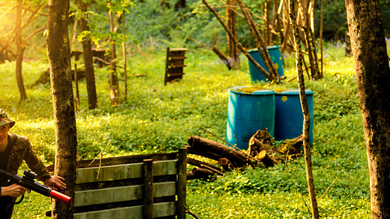 The woodland battle zone with blue barrels and timber barricades