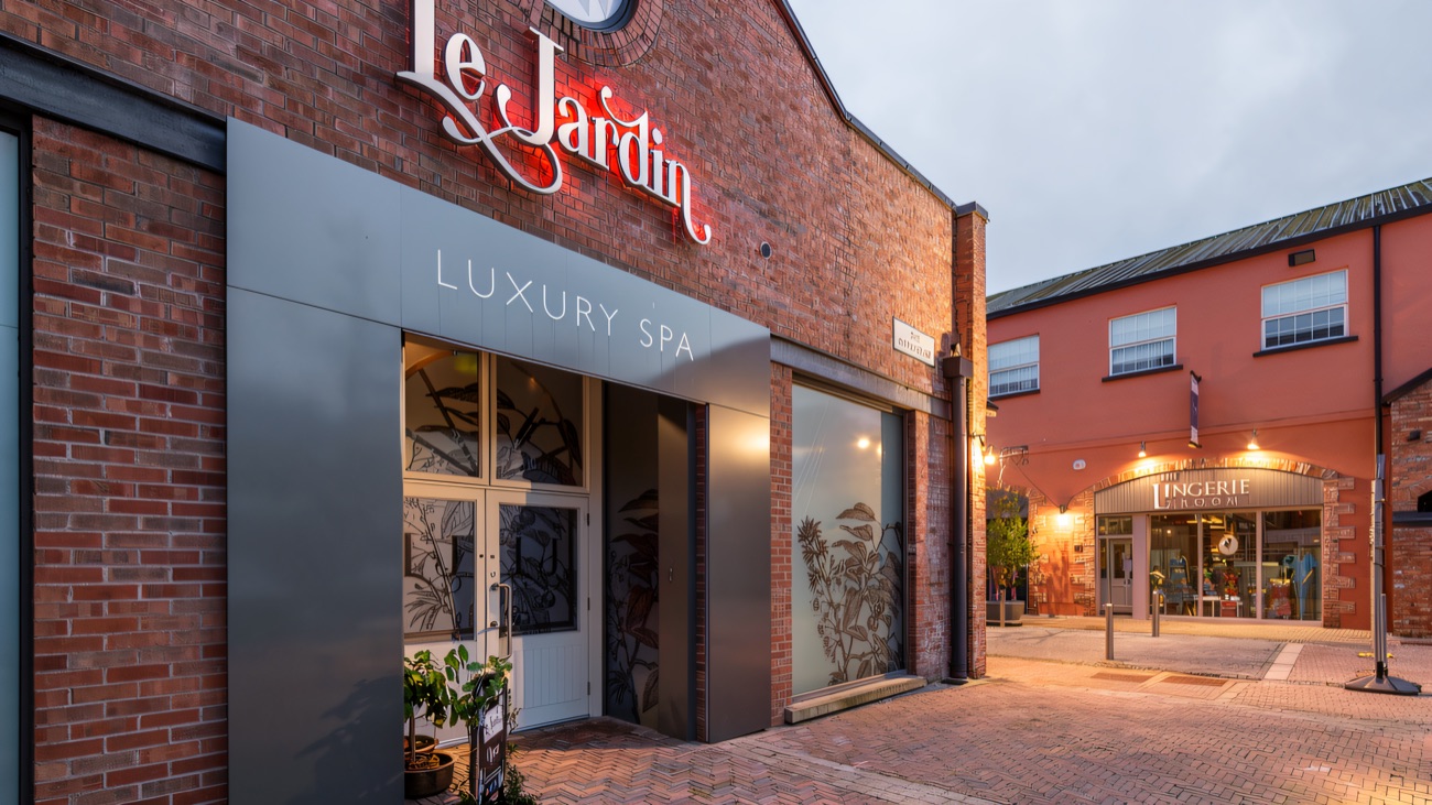 A red-brick courtyard between the units at The Linen Green, with the Le Jardin spa and The Lingerie Room