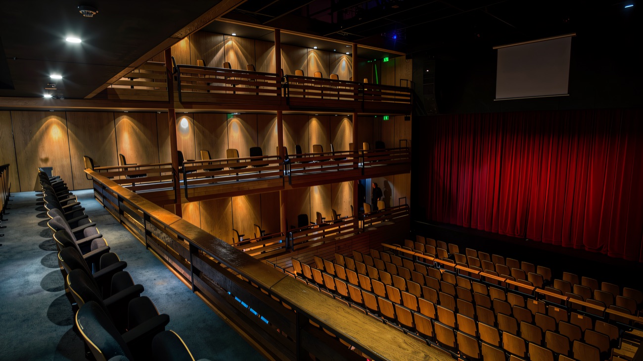 The tiered auditorium with its rich red stage curtain