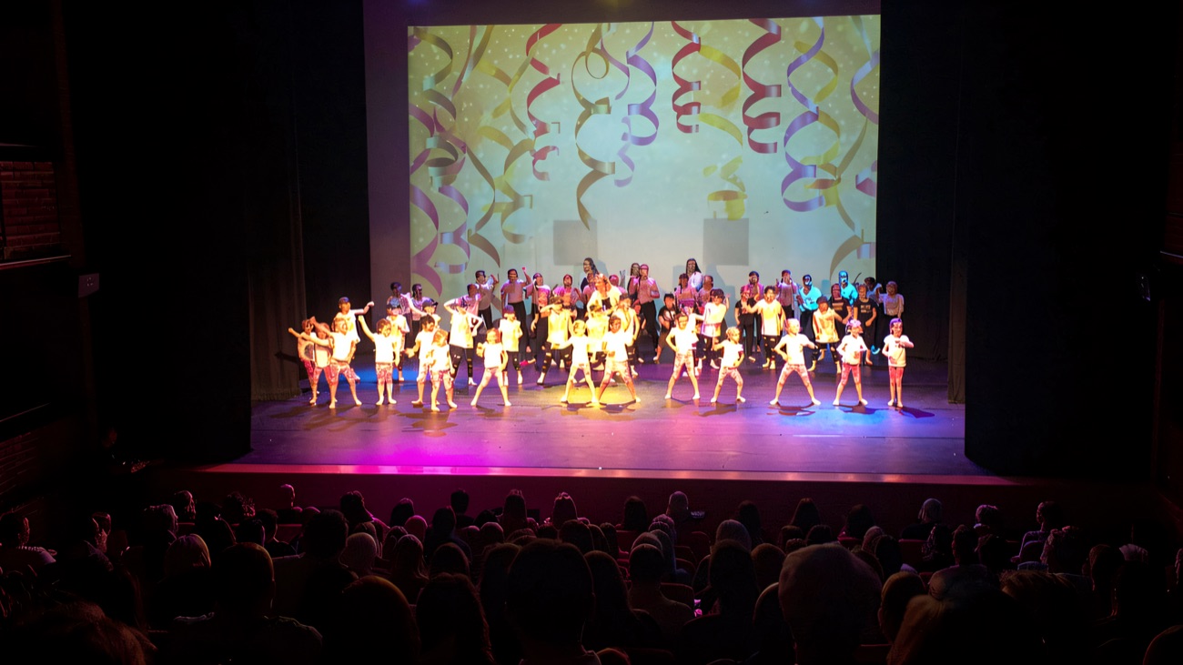 A colourful performance lighting up the stage for a full house