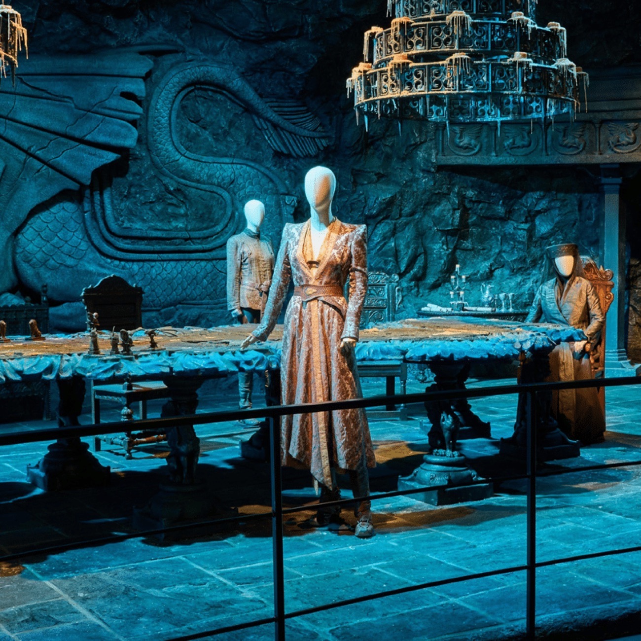 Costumed figures around the carved map table on the Dragonstone set at the Game of Thrones Studio Tour
