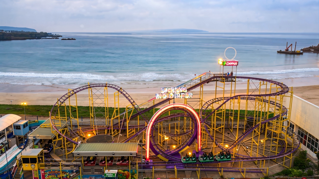 Aerial view of the Big Dipper rollercoaster at Curry's Fun Park with the Portrush beach behind