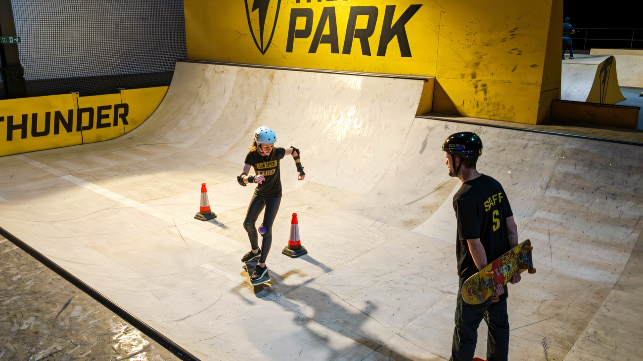 A skate lesson on the plywood ramps beneath the big Thunder Park wall