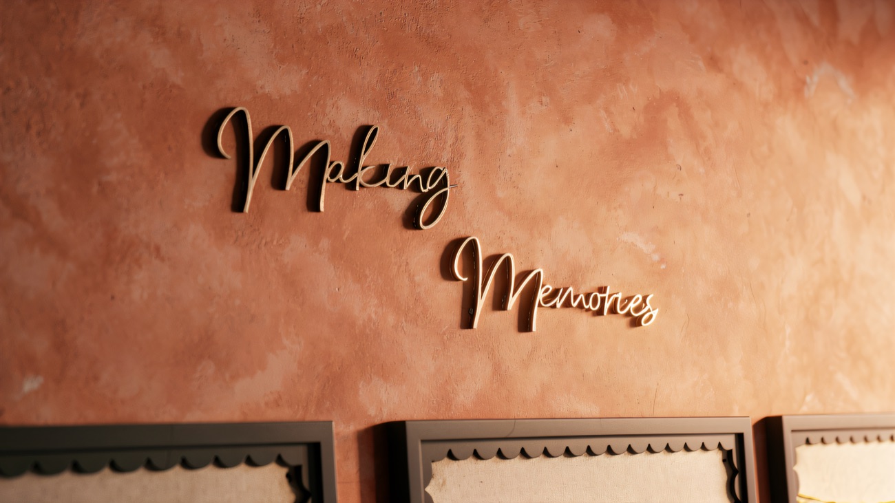 Making Memories lettering on the peach studio wall above display boards