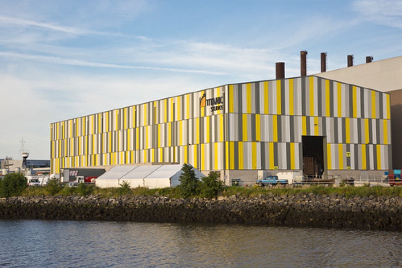 The long striped facade of Titanic Studios across the water, TITANIC STUDIOS sign on the end