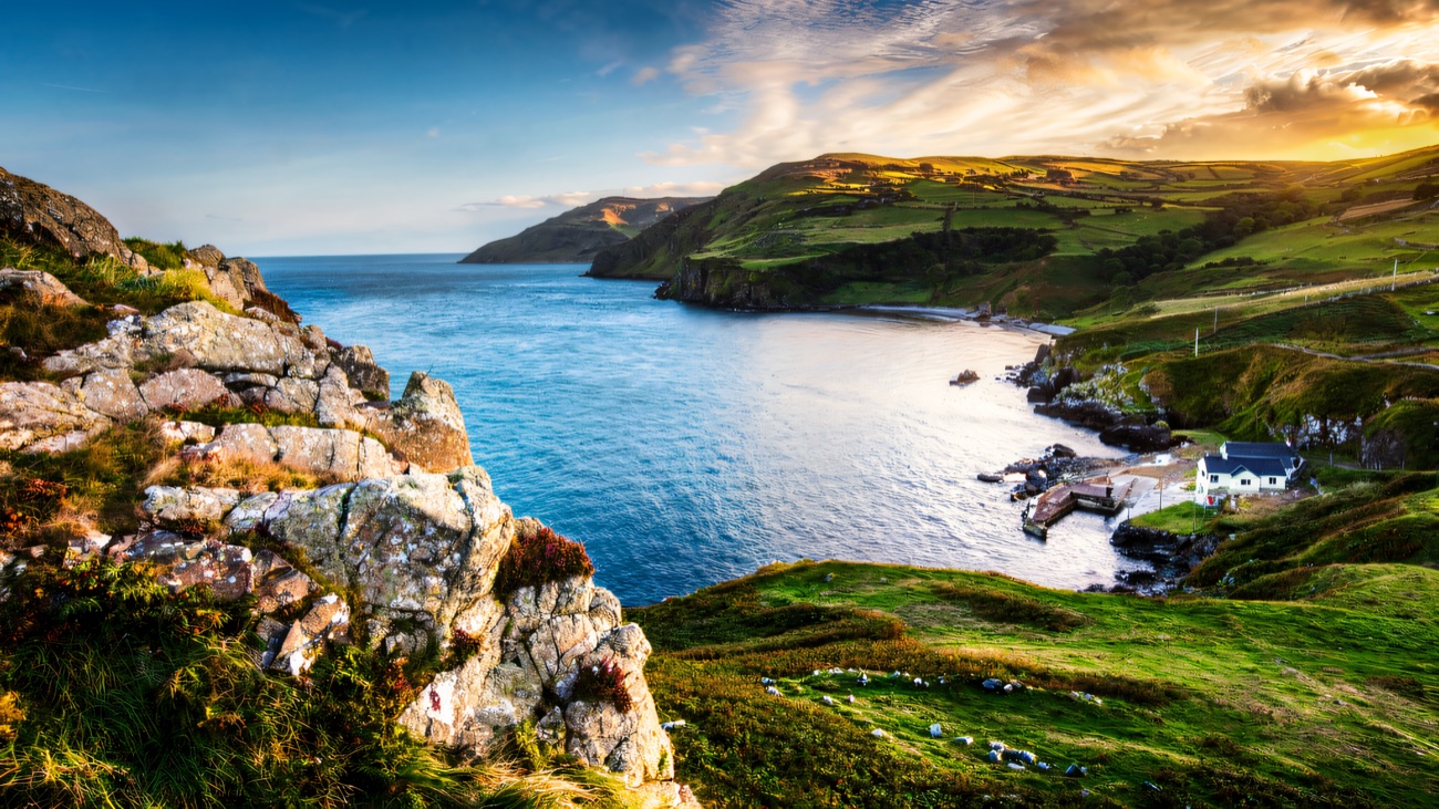 A rocky bluff above the cove, warm evening light on the hills