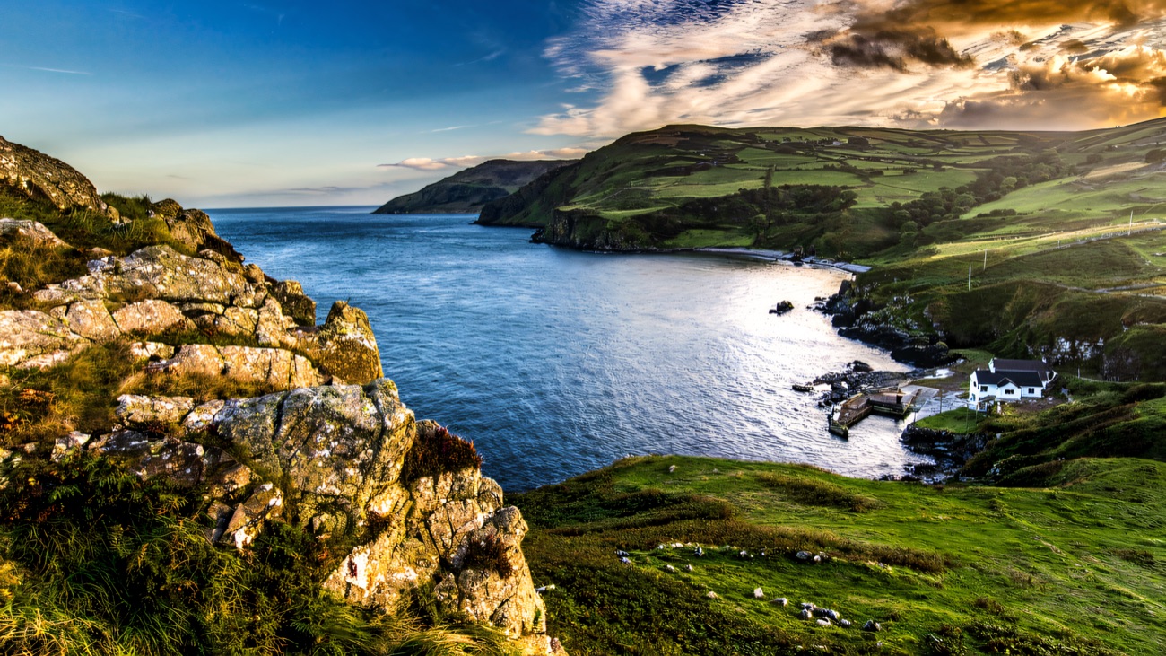The sweep of Murlough Bay with its white cottage below the cliffs