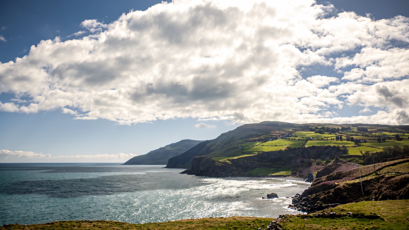 A bright sea view along the coast, sun scattering on the water