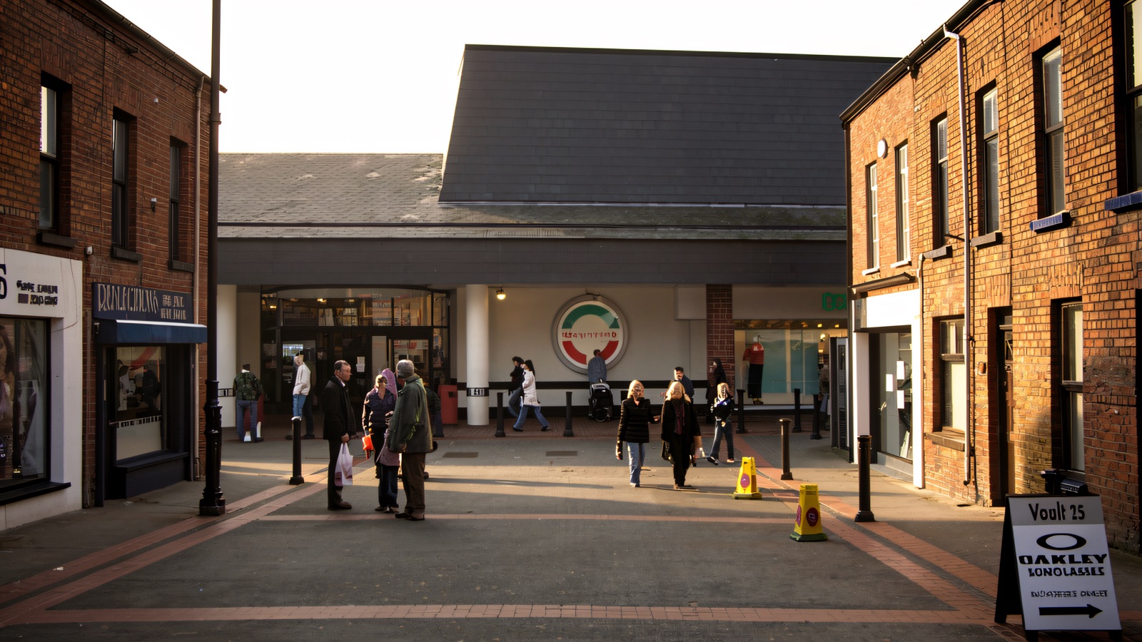 The pedestrian entrance to the Tower Centre in Ballymena town centre, with shoppers on the paved street outside
