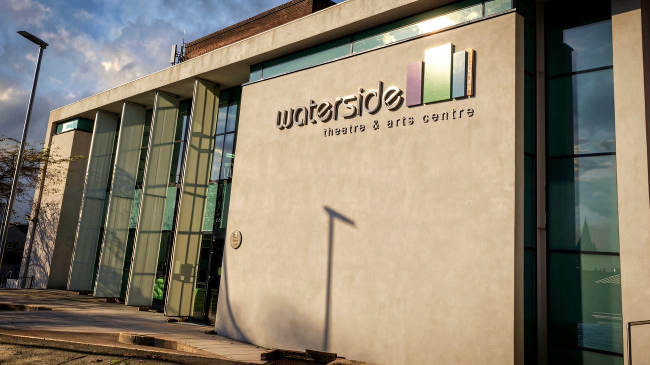 Sunlit signage on the Waterside's stone facade
