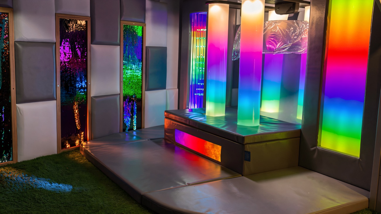 A quiet sensory corner lit by colour-changing bubble columns