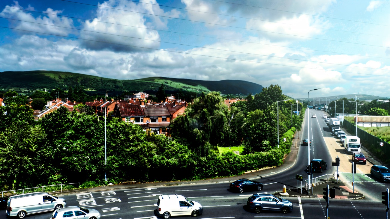 Kennedy Way, the dual carriageway the Westwood Centre sits on in west Belfast, with the Black Mountain and the Belfast hills rising behind