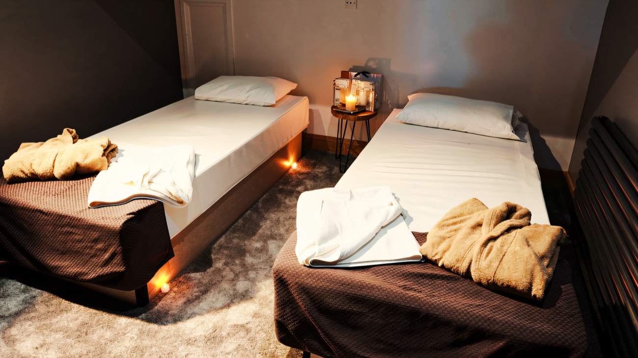 The relaxation room set up with robes and towels for a spa day.