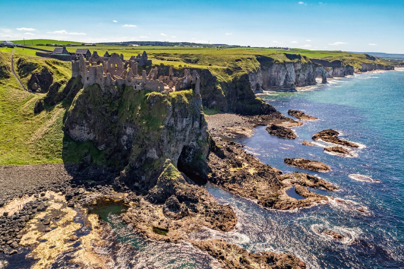 Dunluce Castle perched on the cliffs along the coast east of Whiterocks Beach