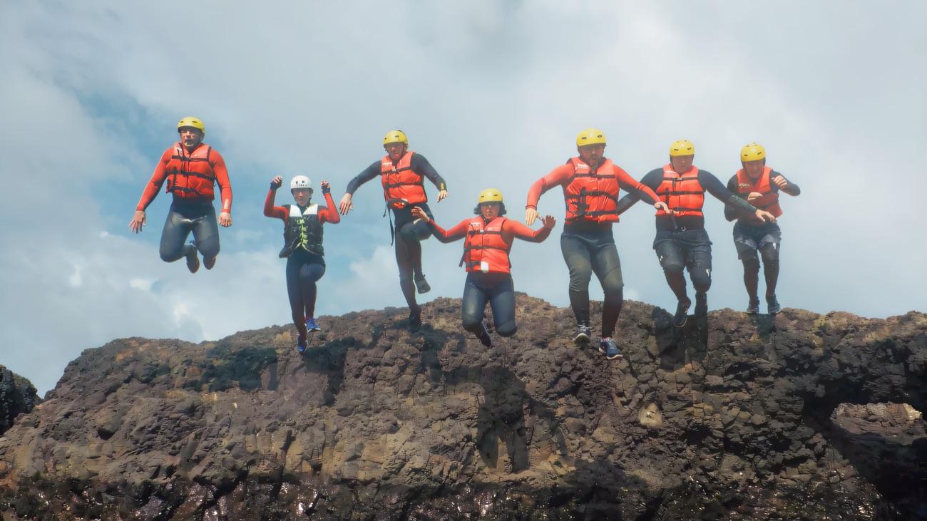 The whole group leaping off the ledge, coasteering at its best